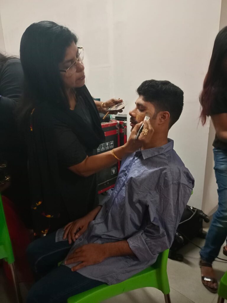 One of our blind student is getting ready for the fashion show with final make up touch.