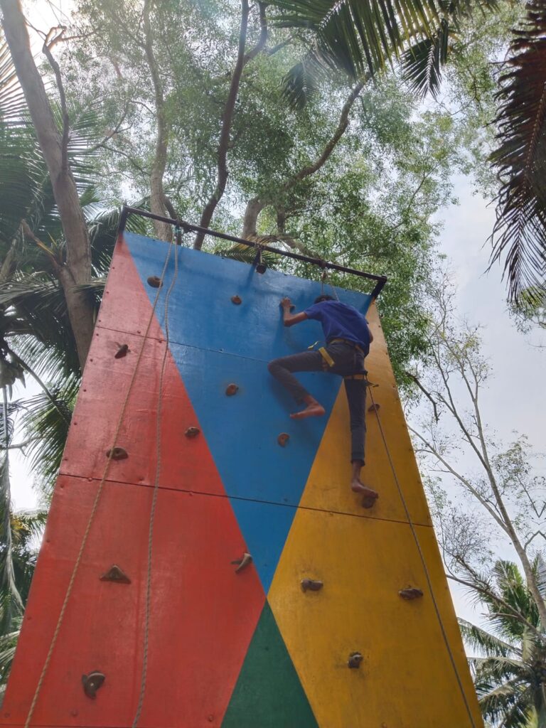 Our blind student eagerly participating in rock climbing.