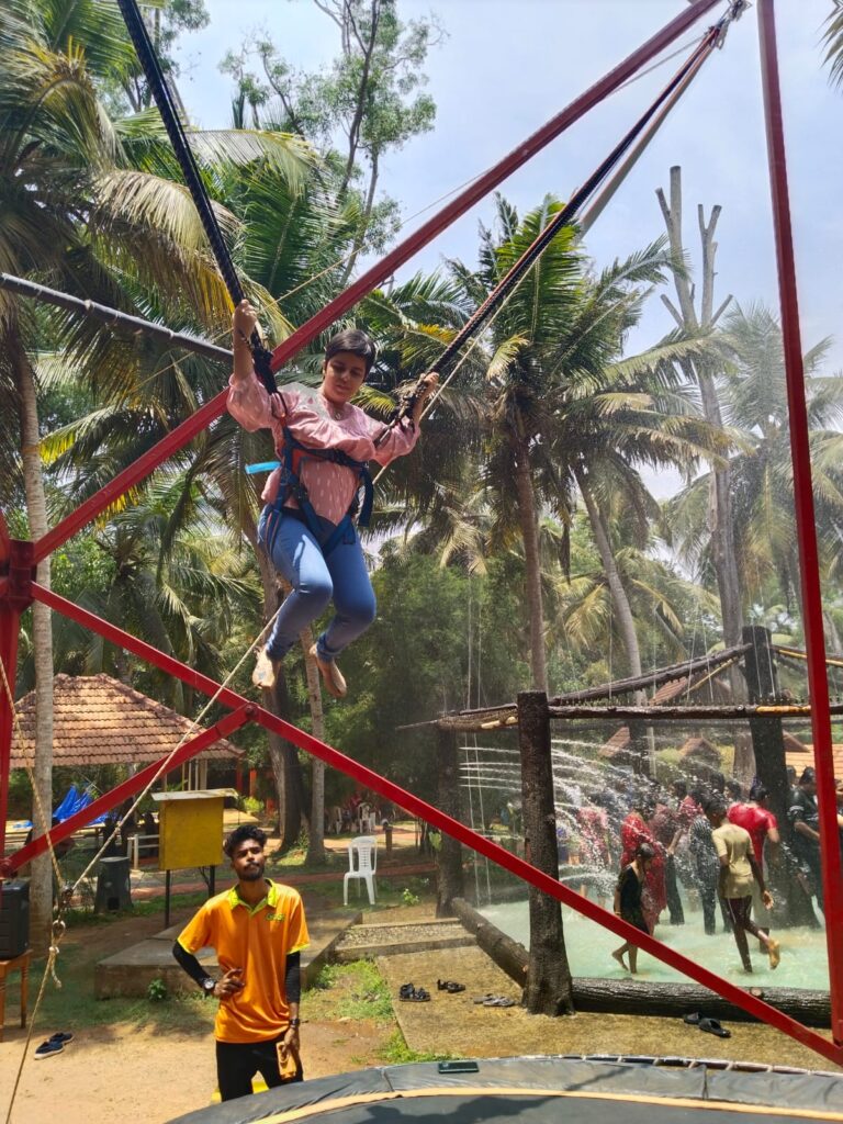 Our Founder enjoying trampoline activity with volunteers monitoring the activity.