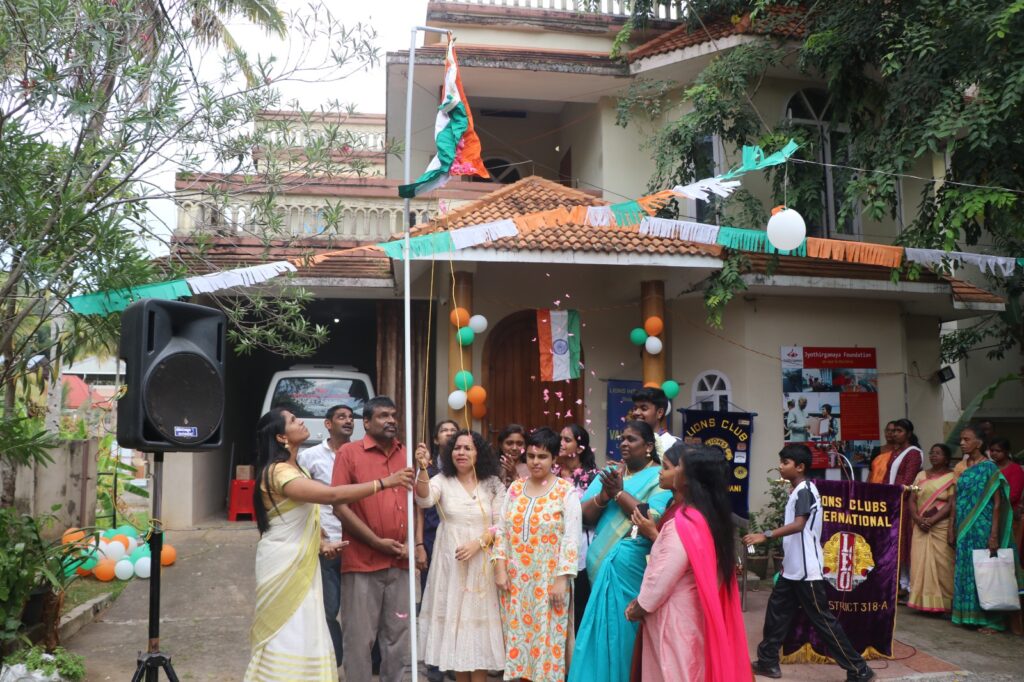 Flag hoisting done by Madam Sri Vidhya in Jyothirgamaya campus where Christ Nagar School students, team members of Jyothirgamaya and all participants were standing nearby.